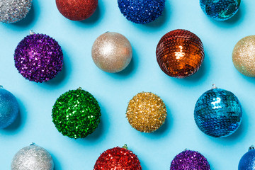 Top view of colorful Christmas balls on blue background. New Year time concept