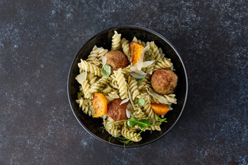 Pasta with meatballs and homemade parsley pesto sauce. Copy space.