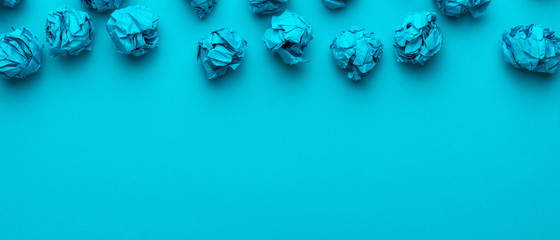 Crumpled paper on turquoise blue background and copy space brainstorming concept