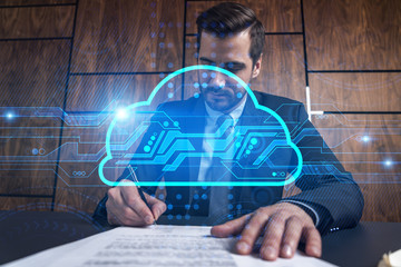 Businessman signs contract and data cloud icon hologram. Double exposure. Formal wear.
