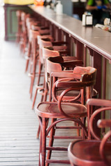High brown bar stools are empty