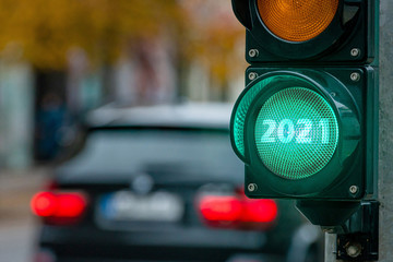 A city crossing with a semaphore. Green light with text 2021 in semaphore. New Year concept.