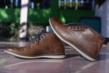 Elegant brown shoes for men on the floor.