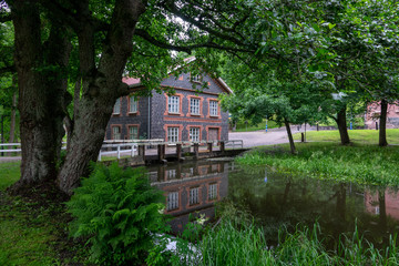 Fiskars village and its mill in the summer time. Former iron works mill built of slag brick (built...
