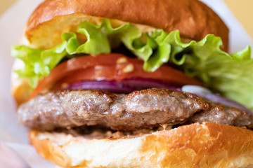 Hamburger with salad, close up and selective focus.