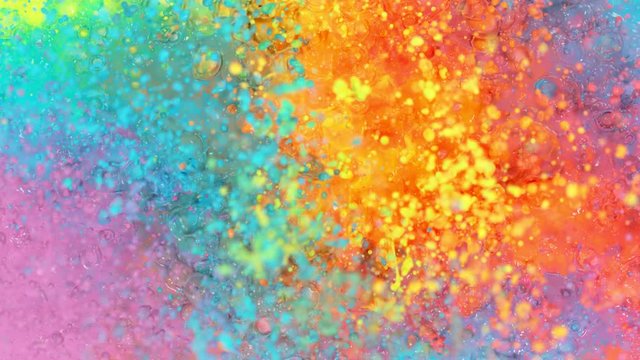 Super slow motion of abstract colored splashes explosions filmed from top. Filmed on high speed cinema camera, 1000 fps.