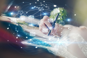 E-mail abstract envelop drawing over hands taking notes background. Concept of electronic mail. Double exposure