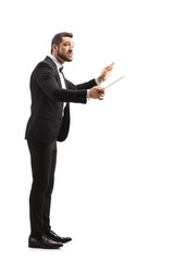 Full length profile shot of a music conductor directing a performance