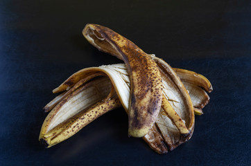 Detailed photo Discarded banana peel on black background.