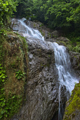 Fototapeta na wymiar Waterfall by the main road between Batumi and Sarpi, Adjara, Georgia.