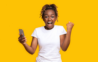 Lucky african woman won lottery, holding mobile phone