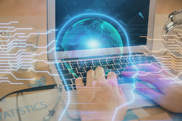 Fototapeta na wymiar Man typing on keyboard background with brain hologram. Concept of big Data.