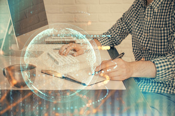 Multi exposure of world map hologram with man working on computer on background. Concept of...