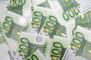 many banknotes of 100 Euro, the European currency, the concept of income and inflation