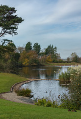 Ducks, geese and swans enjoy the autumn sunshine on an artificial lake.