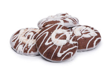 Group of round chocolate cookies drizzled with white icing