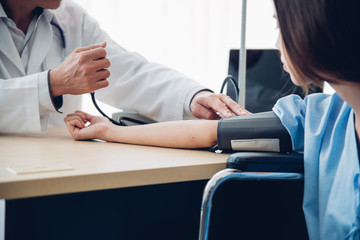 Cropped Hands Of Doctor Examining Patient At Clinic
