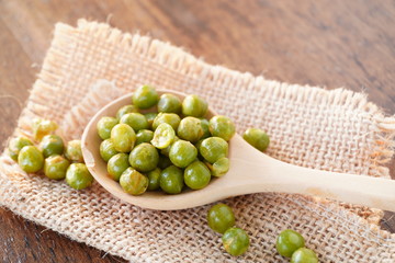 Salted green beans close up, old wooden table