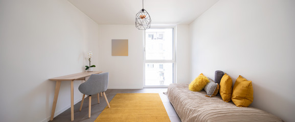 Nice bedroom with a desk, chair and bed. A lot of light enters through the window