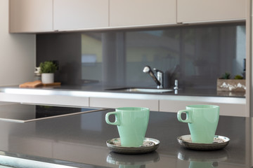 Fototapeta na wymiar Detail of two breakfast cups in a modern and design kitchen