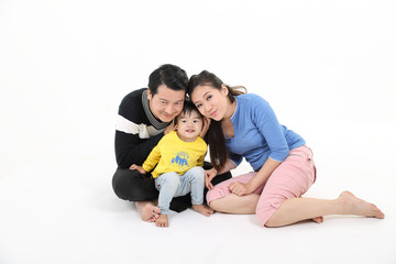South East Asian Chinese couple husband wife son child play sit on floor look at camera white background love
