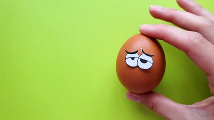 funny tired easter egg in hand