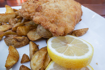 Cordon bleu steak with potatoes and lemon