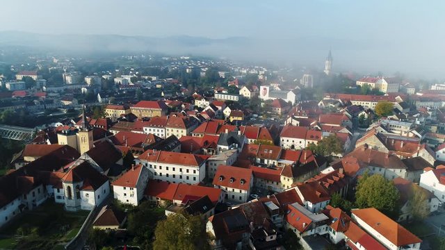 Panoramic drone view of an old town Novo mesto with haze in the background