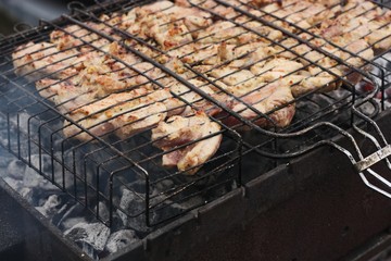 Chicken meat with spices on a barbecue grill