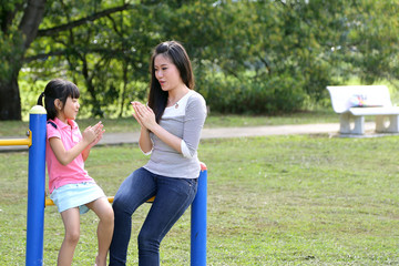 South East Asian young Chinese mother daughter parent child play relax activity outdoor park smile love