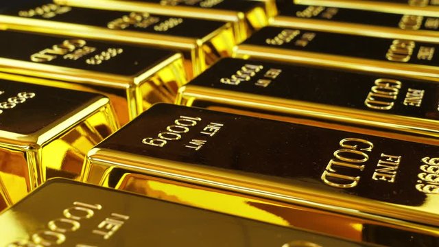 Gold bullion or a gold ingot. Stacked bullion bars. Seamless looping footage. Camera revolves around gold bars. Etching 999,9 Fine Gold, Net WT 1000g engraved into them