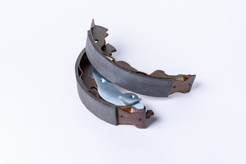 New brake pads for disc brakes on a wooden table.