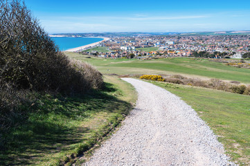View of Seaford town in East Sussex, England from the golf course, beach and blue sea, selective focus