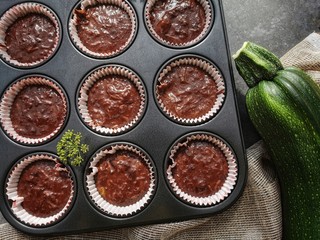 Preparation homemade zucchini muffins with chocolate. Selective focus. Top view. 