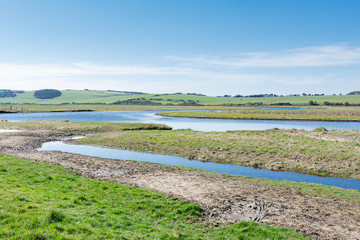 Views of Cucmere river near Seaford and Eastbourne, East Sussex, footpath leading to Cuckmere Haven beach, selective focus