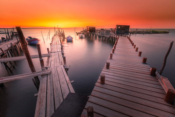 Sunset at Carrasqueira's palafitic sea port. A traditional maritime port for local fishermen.