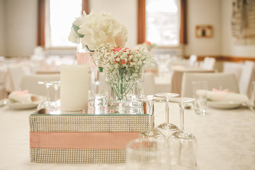 Elegant pastel pink-white wedding day ceremony decoration with flowers, mirror, decorated table for beautiful celebration. Location Alzey, Germany.