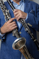 Close-up of male hands holding clarinet, cropped photo,