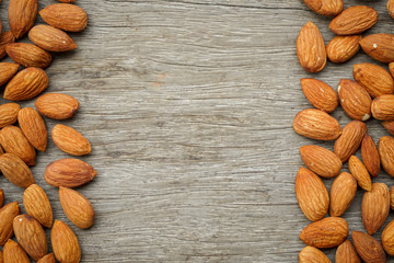 Almonds nuts on an old wood background