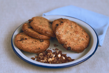 Chocolate chip cookies on a plate on a white background