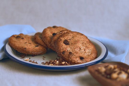 Chocolate chip cookies on a plate on a white background