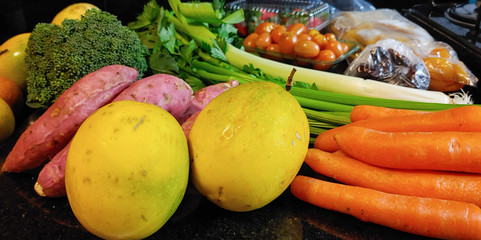 A small variety of fruits and vegetables that have just arrived from the organic fair.
