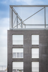 Modern dark brick building with windows