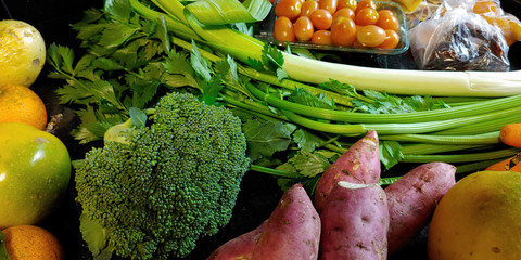 A small variety of fruits and vegetables that have just arrived from the organic fair.