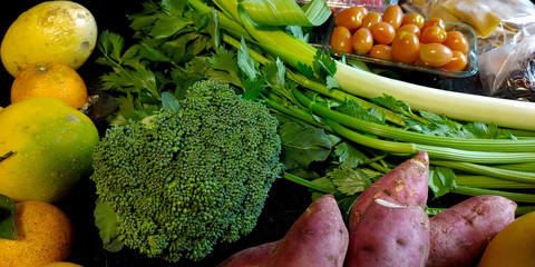 A small variety of fruits and vegetables that have just arrived from the organic fair.