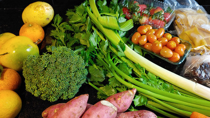 A small variety of fruits and vegetables that have just arrived from the organic fair.