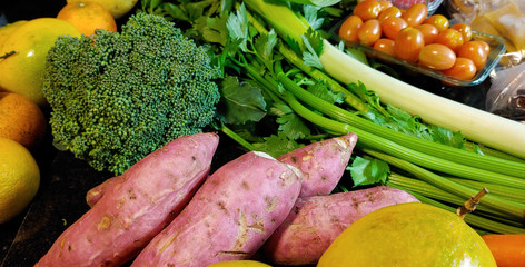 A small variety of fruits and vegetables that have just arrived from the organic fair.