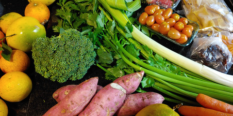 A small variety of fruits and vegetables that have just arrived from the organic fair.