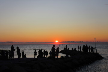 Sunset on Rock Harbor, Cape Cod with people Silhouettes