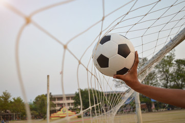 The soccer ball was pushed into the net.